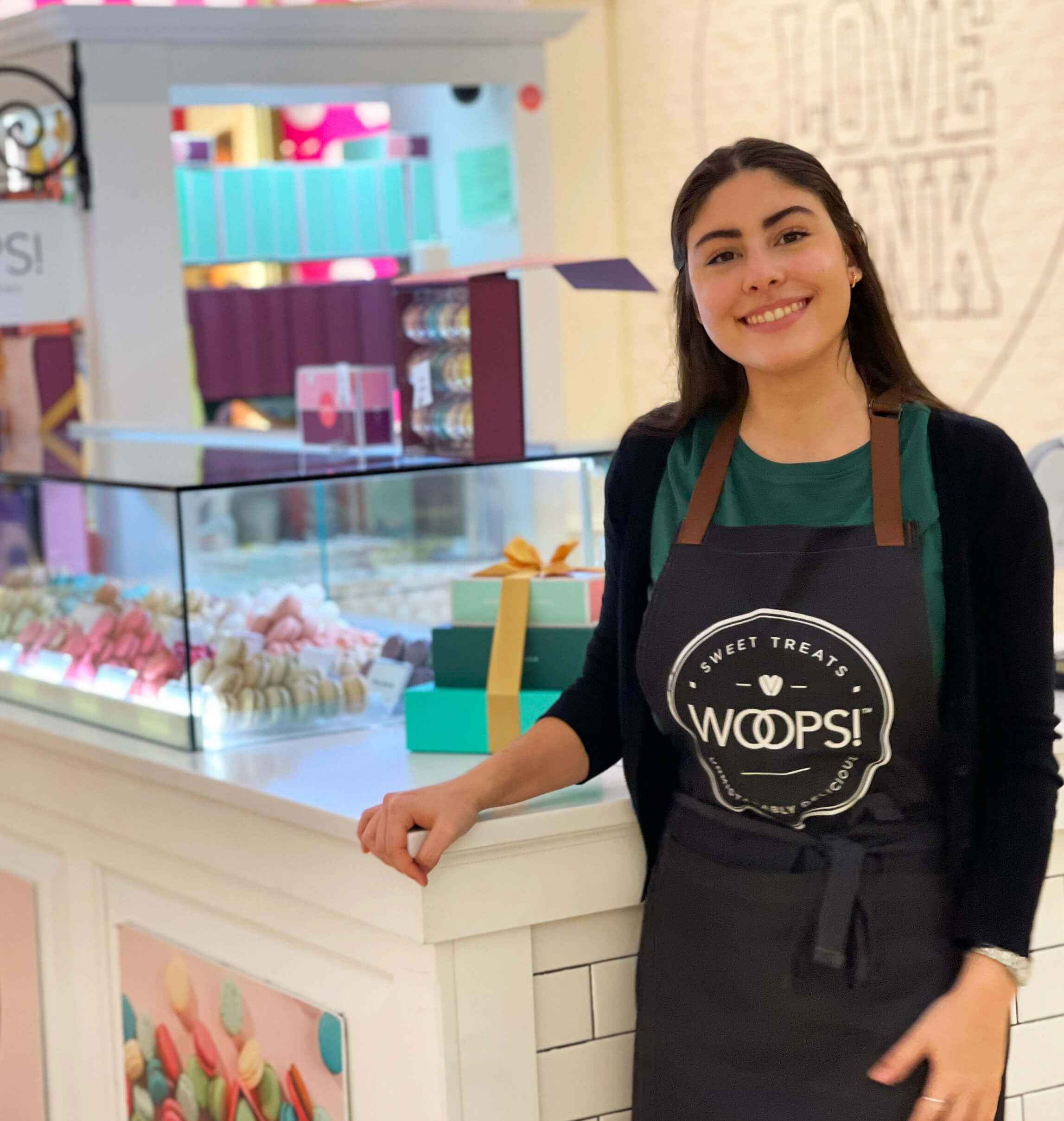 Owner of Woops! French Macaron Franchisee at the with a counter at the back