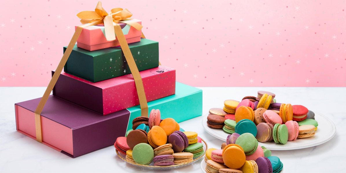 Macaron Stack with different sized boxes and holiday sleeves, filled with assorted macaron flavors