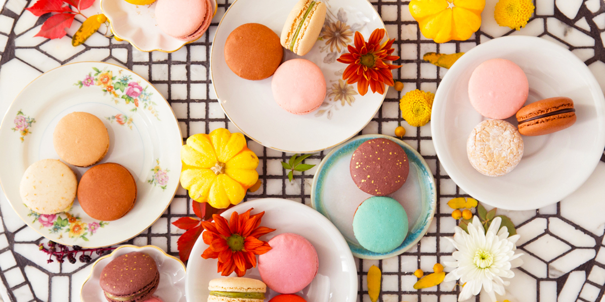 Colorful Woops! macarons and flowers on a table