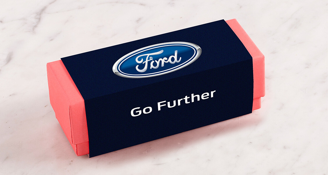 A French macaron favor box has a Ford customized sleeve.
