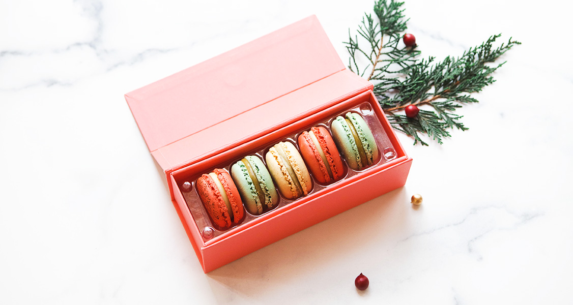 A French macaron Premium Favor Box of 5 with assorted flavors has a tiny piece of pine to the right.