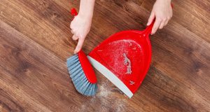 Two female hands are sweeping a wooden floor. https://asianinspirations.com.au/experiences/how-to-prepare-for-the-lunar-new-year/ 