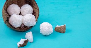 Coconut candy, coconut flakes, and coconut on a blue background