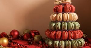 A French macaron pyramid is surrounded by holiday ornaments