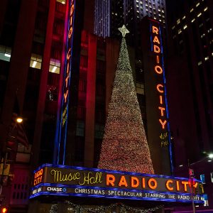Radio City Music Hall with a big Christmas tree on top.