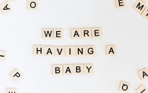 Black and white plastic letters spelling “we are having a baby”.