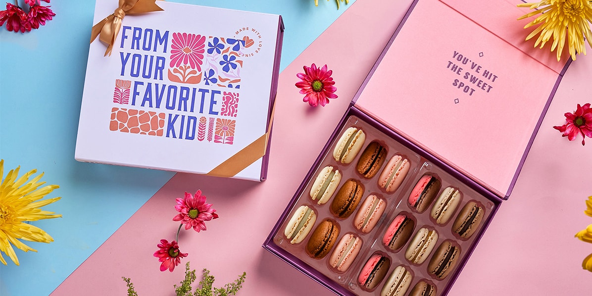 Two macaron boxes, one opened, the other with Mother’s day theme.