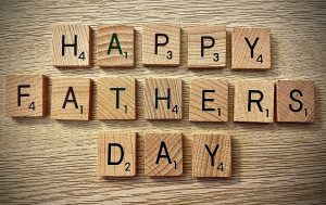 Brown scrabble letters spelling out "Happy Fathers Day"