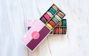Two Woops! boxes of 12 assorted macarons.