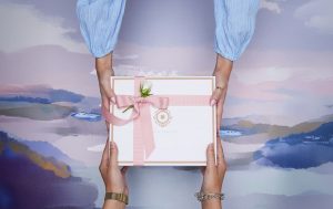 Someone giving and someone receiving a corporate gift.